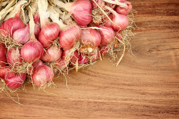 Shallot onions in a group on wood