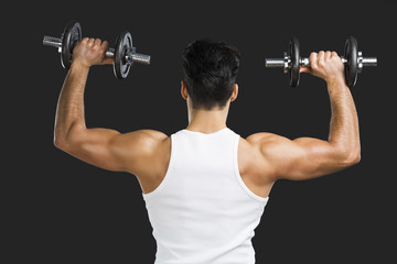 Fototapeta na wymiar Athletic man lifting weights
