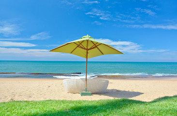 Fototapeta na wymiar Beach Umbrella And Sunbath Seats 