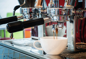 prepares espresso in coffee shop