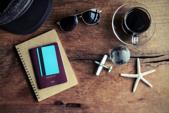 Outfit of traveler with cup of coffee on wooden background
