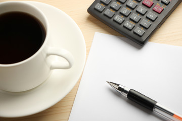 White paper calculator and coffee