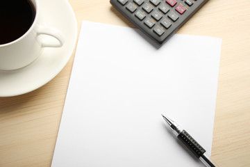 White paper calculator and coffee