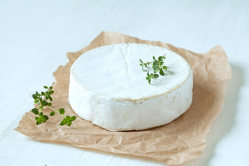 Camembert cheese traditional french gourmet food with thyme on