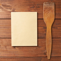 Wooden spatula next to empty sheet
