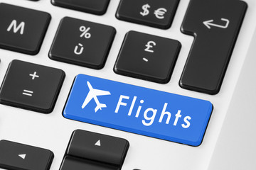 Close-up of flight button on keyboard for online booking