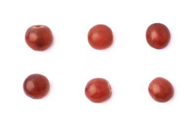 Six single dark red grapes isolated