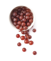 Dark red grapes spilled out of bowl