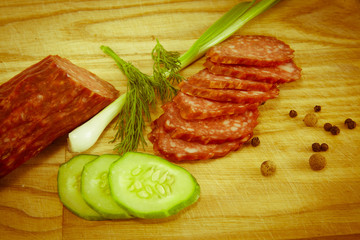 salami sausages on wooden board isolated