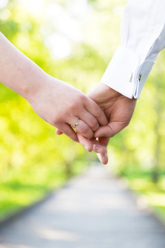 Holding hands close-up. Couple in love dating