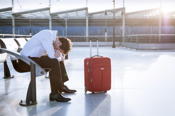 Businessman in working on laptop in airport waiting lounge