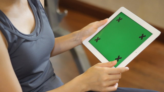 Fitness woman using tablet in the fitness club 