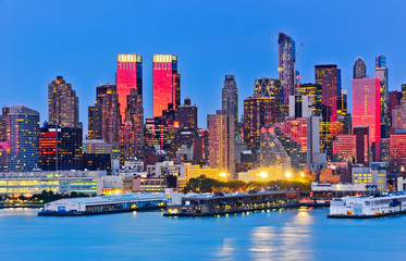 Fototapeta premium Manhattan skyline with red sunlight reflection.