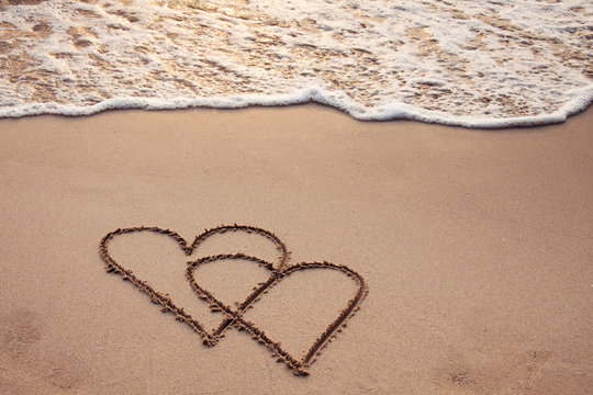 Honeymoon, Two hearts drawn on sand beach