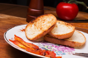 a slice of toasted bread crust with tomato sauce