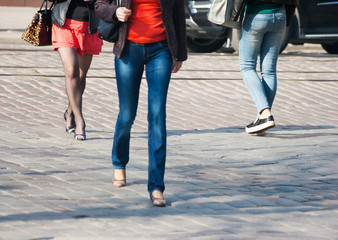 legs of pedestrians on a pedestrian crossing