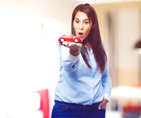 surprised young woman with red car