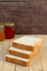 Sliced Bread on wood plank background.