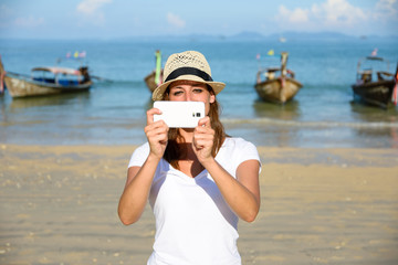 Tourist on Thailand travel taking photos with smartphone at Krab © Dirima