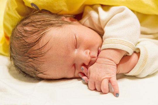 photo of a sleeping newborn baby closeup