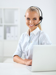 Close-up portrait of a customer service agent sitting at office