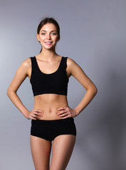 Fototapeta premium Portrait of beautiful sports woman with hands on hips 