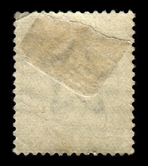 Reverse side of a postage stamp.