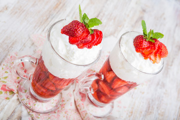 Strawberries in jelly topped with whipped cream