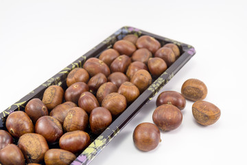 Chestnut in beautiful tray focus at foreground.