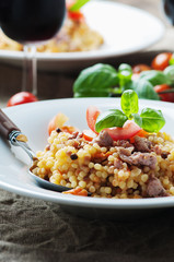Cooked sardinain pasta fregola with tomato and sausage