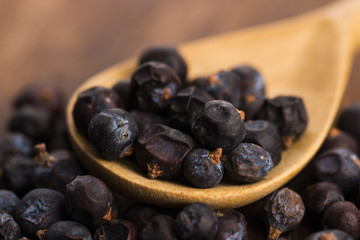 Juniper berries on a wooden background