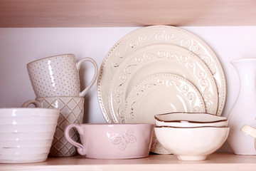 Kitchen utensils and tableware on shelf