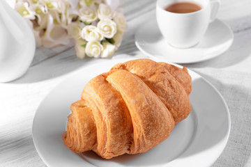 Delicious croissants on plate on table close-up