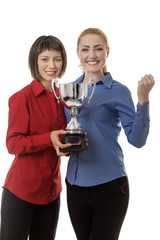 two business woman holding up a trophy
