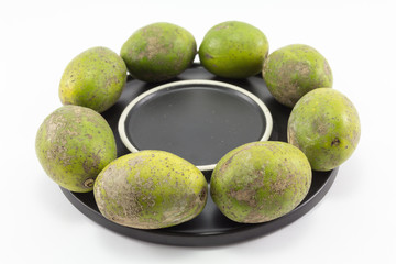 Hog plum on black plate with isolate background.