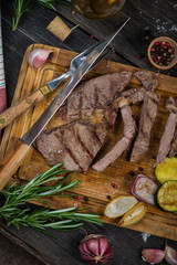 Medium rare grilled ribeye steak on cutting board