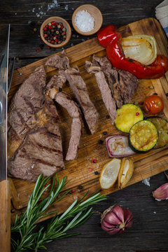 Medium rare grilled ribeye steak on cutting board