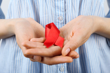 Female hands with color ribbon, closeup