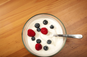 Bowl of yogurt with raspberries and blueberries