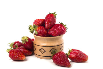 full of red fresh strawberries in a wooden mug