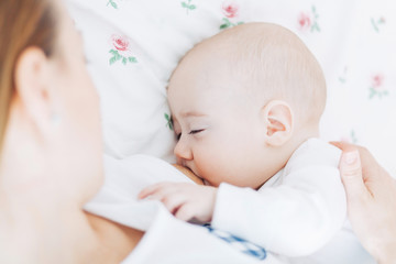 Mother breastfeeding her baby boy