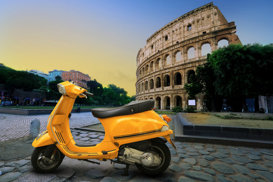 Yellow Vintage Scooter On The Background Of Coliseum