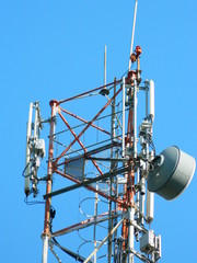 Communication Tower with Parabolic and GSM Antennas, LTE and Blue Sky close up