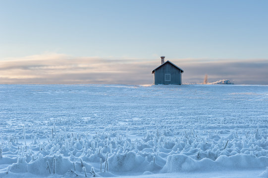 Traditional swedish summer house set in a snow covered oat field, the island of Frösön, Östersund, Sweden.