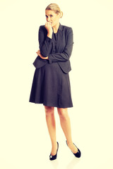 Stressed young woman biting her nails 