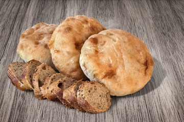 Baguette Integral Bread Slices with Pita Bread Loafs on old Wood.