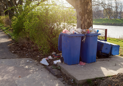 Garbage bins standing among street