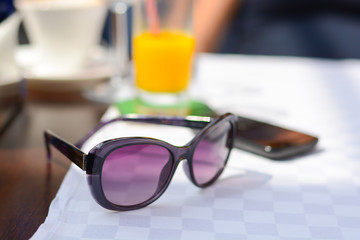 Sunglasses on a restaurant table in vacation