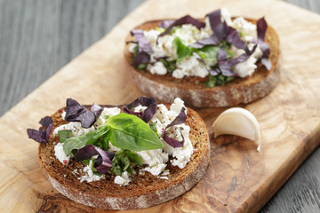 rye sandwich or bruschetta with ricotta, herbs and basil