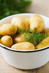 raw baby potatoes on wooden surface